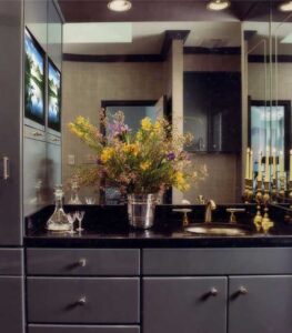 Perfectly Appointed Forest Hills 1989 Bathroom Remodel Ten coats of Dupont automotive lacquer give these contemporary cabinets the durable finish requested for the husband’s master bath. Absolute black granite covers the countertop which features contemporary Kohler faucets and a custom fabricated under-mount bowl with a brushed nickel finish. Individual pieces of gold leaf were hand applied on the walls giving the unique overall appearance reflected in the mirror.
