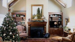 Home for the Holidays fireplace Wexford Estates 2012 A custom walnut fireplace mantle by Vintage Mantle Company of Tulsa, Oklahoma and adjoining walnut bookcases by Woodstock Woodworking of Tulsa, Oklahoma is featured at the end of this living room. This combination replaced a massive red brick fireplace that dominated the space providing a closed-in feeling in the living room.